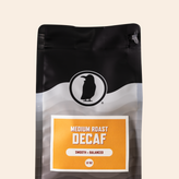 Medium roast decaf coffee bag labeled smooth and balanced, packaged in a 12 oz size.








