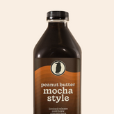 Bottle of limited release Peanut Butter Mocha Style cold brew concentrate with brown and orange label.