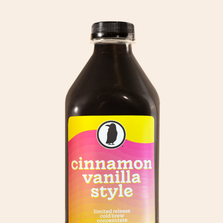Bottle of Rook Coffee’s Cinnamon Vanilla Style cold brew concentrate with a yellow and pink gradient label.