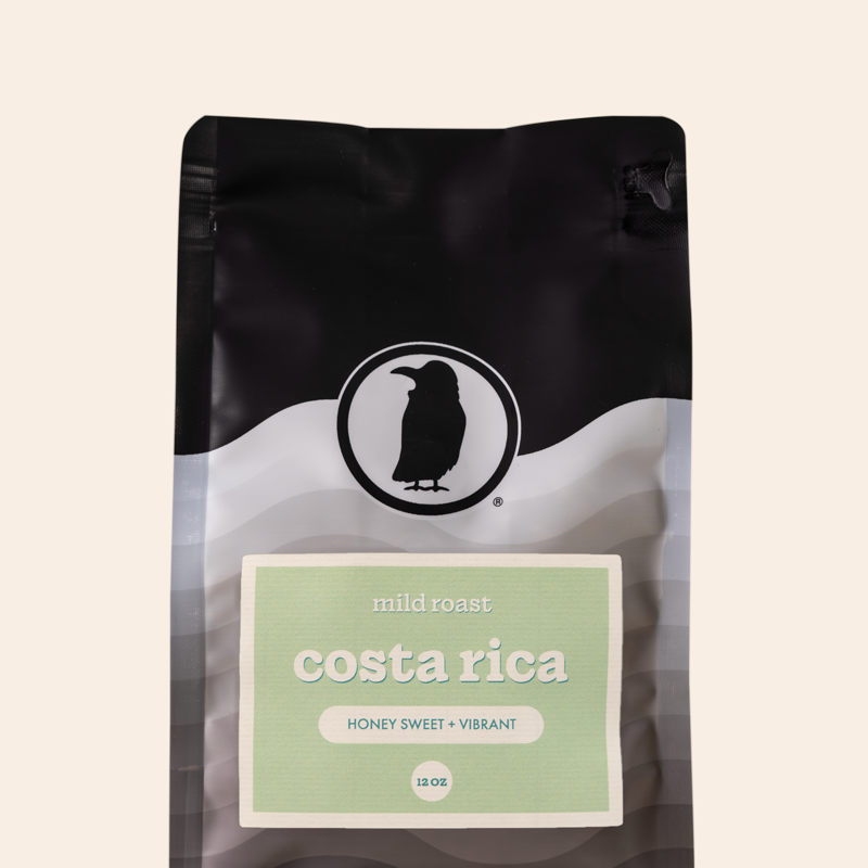 Packaging of a 12-ounce bag of mild roast coffee labeled 'Costa Rica, Honey Sweet + Vibrant,' featuring the Rook Coffee logo at the top. 
