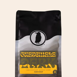 Bag of Rook Coffee Guatemala Dark roast on a beige background. Label reads “Guatemala Dark – Dark Chocolate, Almond, Cherry. Dark Roast.”