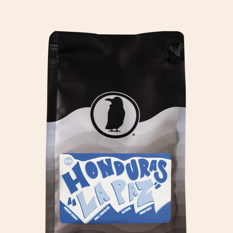 Bag of Rook Coffee’s Honduras La Paz medium roast with a blue and white label featuring bold lettering and tasting notes of milk chocolate, almond, and honeydew.