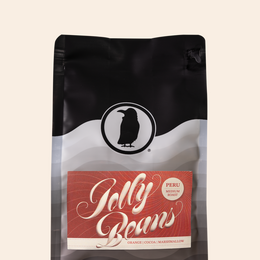 Rook Coffee Jolly Beans bag displaying the limited release Peruvian coffee with orange, milk chocolate and caramel flavor notes.