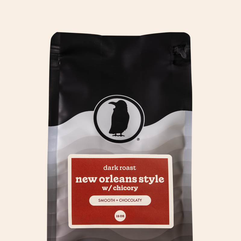 Packaging of a 12-ounce bag of dark roast coffee labeled 'New Orleans Style with Chicory, Smooth + Chocolaty,' featuring the Rook Coffee logo at the top.