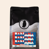 Bag of Panama Finca La Santa coffee with red, white, and blue label reading ‘Panama’ repeated three times; flavor notes include brown sugar, milk chocolate, and orange.