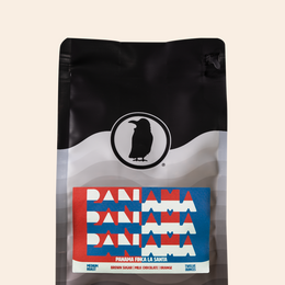 Bag of Panama Finca La Santa coffee with red, white, and blue label reading ‘Panama’ repeated three times; flavor notes include brown sugar, milk chocolate, and orange.