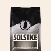 Rook Coffee Solstice bag with a bold black and white label, described as a medium-dark roast from Burundi with notes of black tea, candied lemon, and pink lady apple.