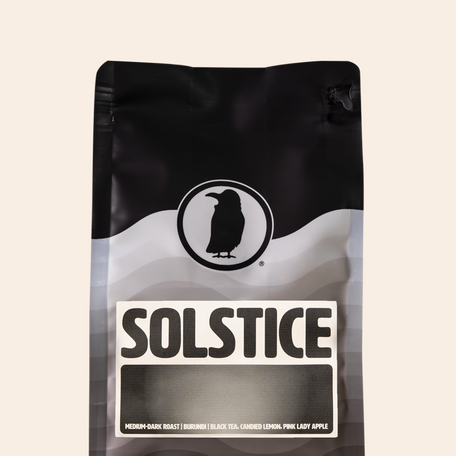 Rook Coffee Solstice bag with a bold black and white label, described as a medium-dark roast from Burundi with notes of black tea, candied lemon, and pink lady apple.