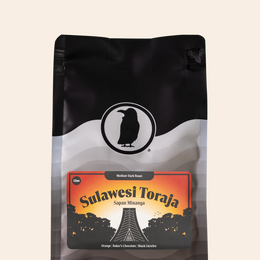 Bag of Sulawesi Toraja medium-dark roast coffee with notes of orange, baker’s chocolate, and black licorice.