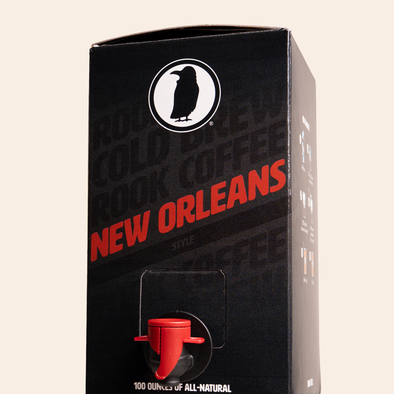 Boxed Rook Coffee cold brew with a black package, red ‘New Orleans’ text, and the Rook Coffee bird logo near the top. A red dispensing spout is visible on the front.