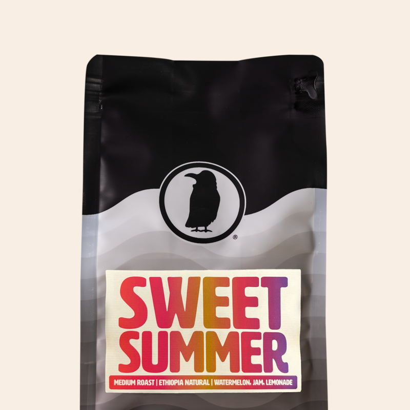 Bag of Rook Coffee Sweet Summer medium roast coffee featuring the Rook Coffee logo and colorful text. The label lists tasting notes of watermelon, jam, and lemonade. Product shown against a transparent background.