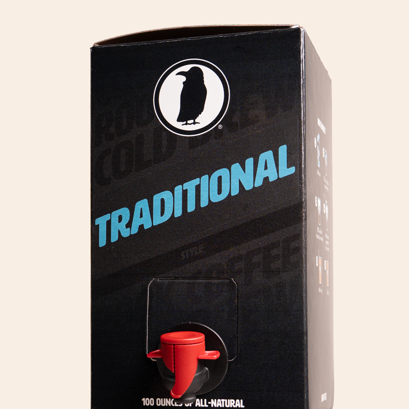 Boxed Rook Coffee cold brew with a black package, blue ‘Traditional’ text, and the Rook Coffee bird logo near the top. A red dispensing spout is visible on the front.