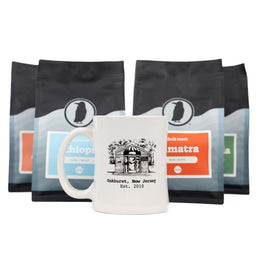 White mug with an illustration of the original Rook Coffee, placed in front of four Rook Coffee bags.