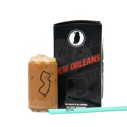 Rook Coffee New Orleans Style cold brew Brew Box next to a glass of iced coffee with a mint green straw.
