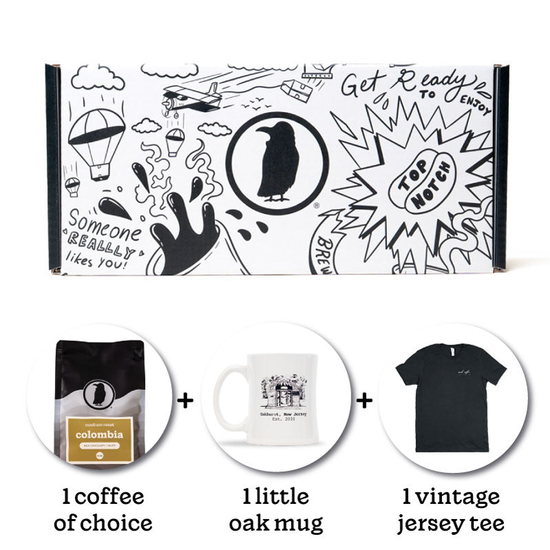 Rook-branded gift box with a bag of Rook Coffee, one branded mug, and one t-shirt below. Text reads "1 coffee of choice" + "1  little oak mug" + "1 vintage jersey tee".